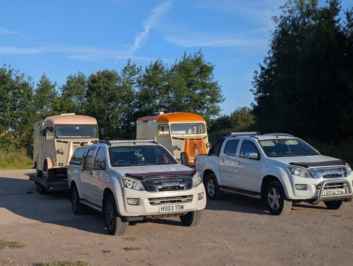 Beetle Juice tow vehicles transporting Citroën HY vans on a trailer