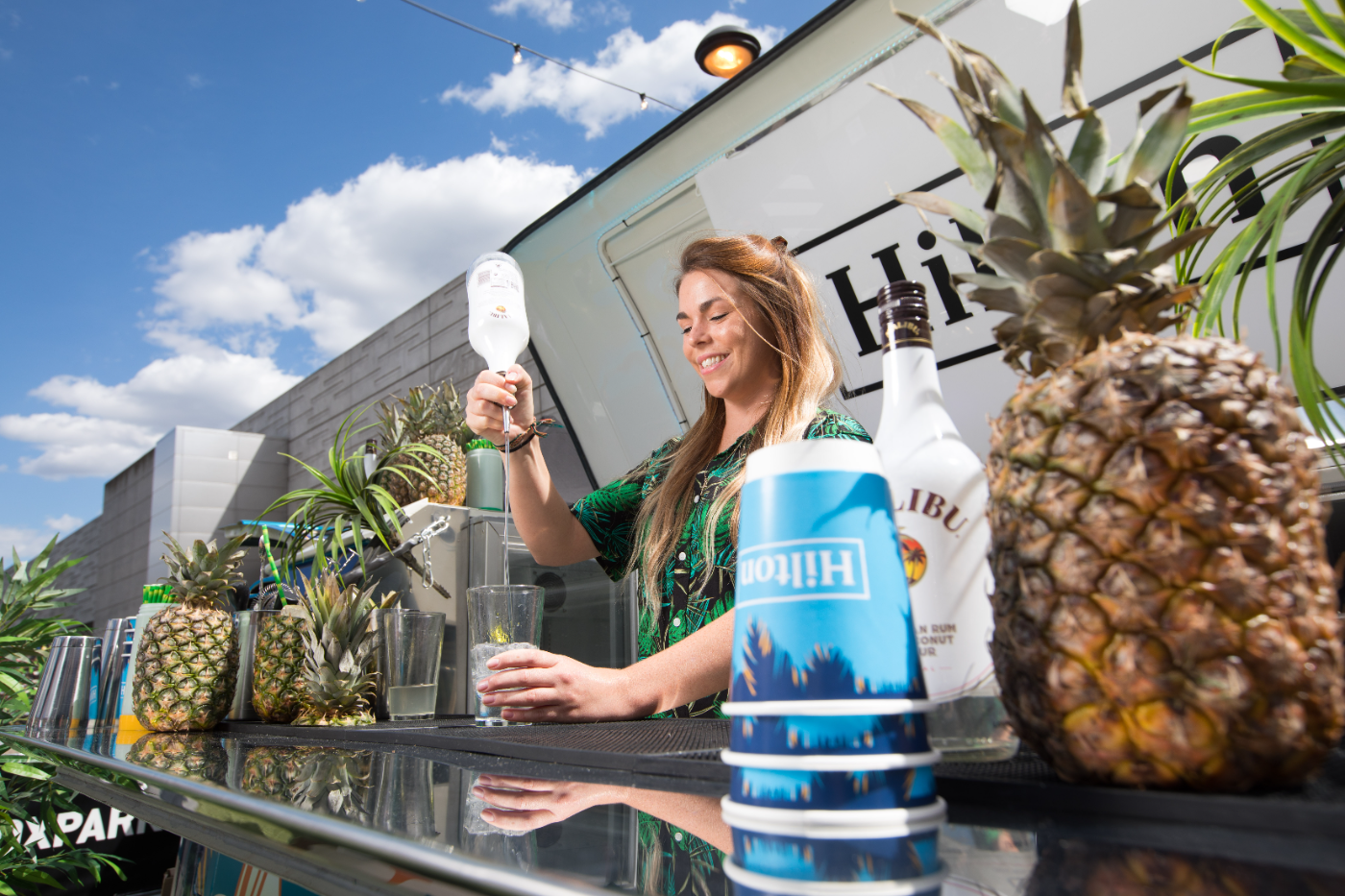 Hilton-branded VW bar serving tropical cocktails with pineapples