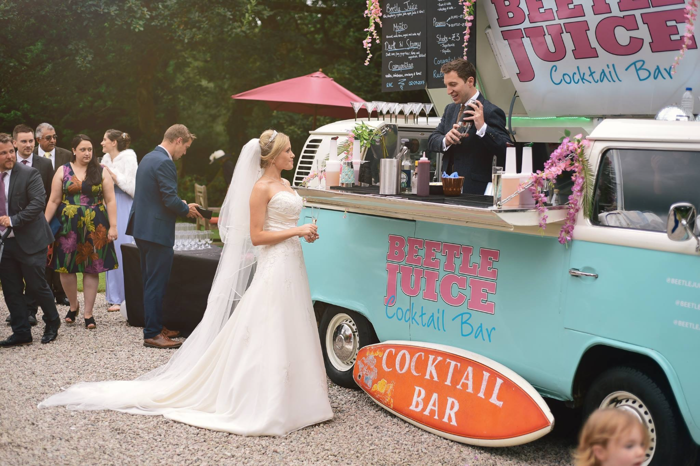 Bride at the teal Beetle Juice VW cocktail bar at a wedding